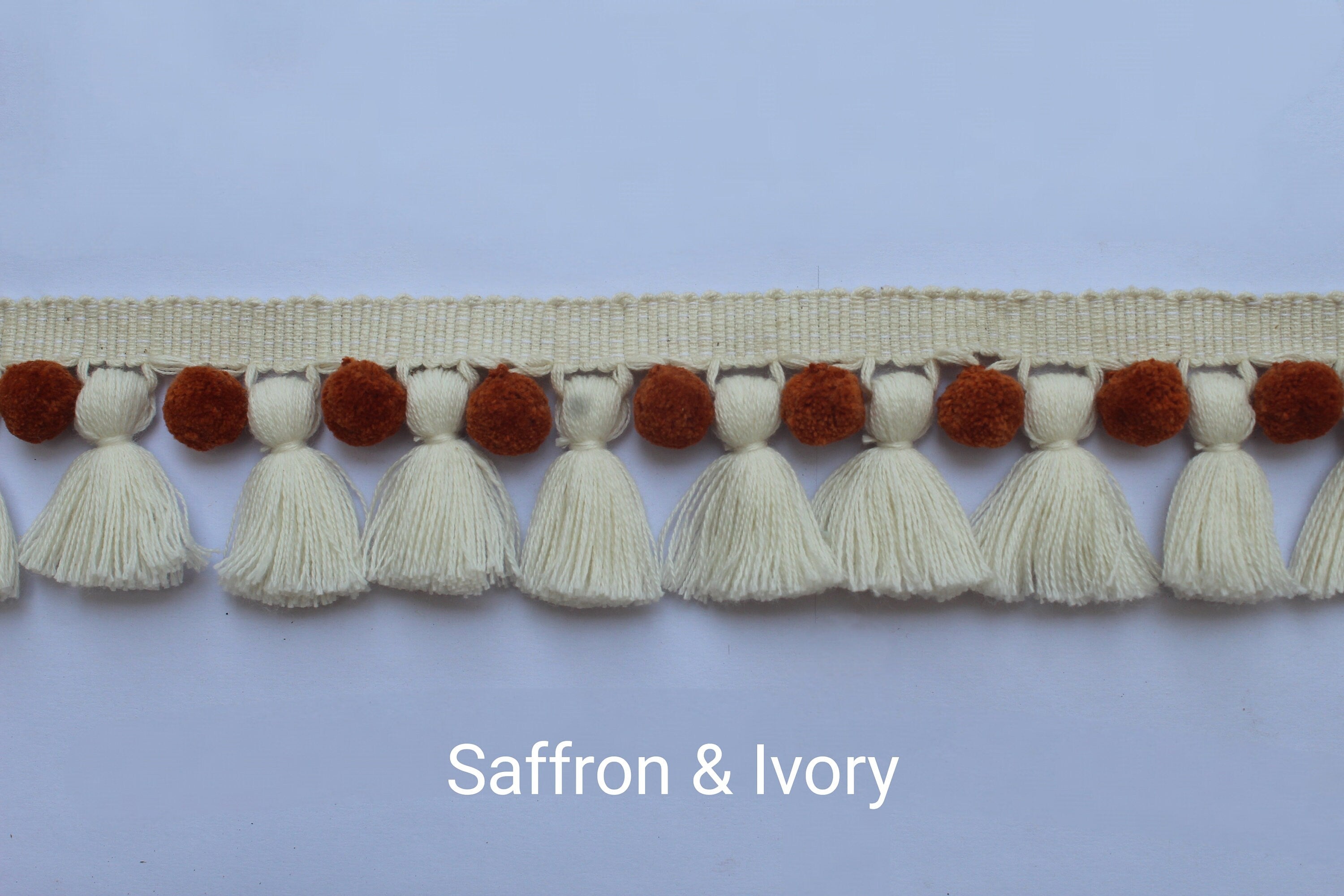 Saffron and ivory pom poms tassel trim