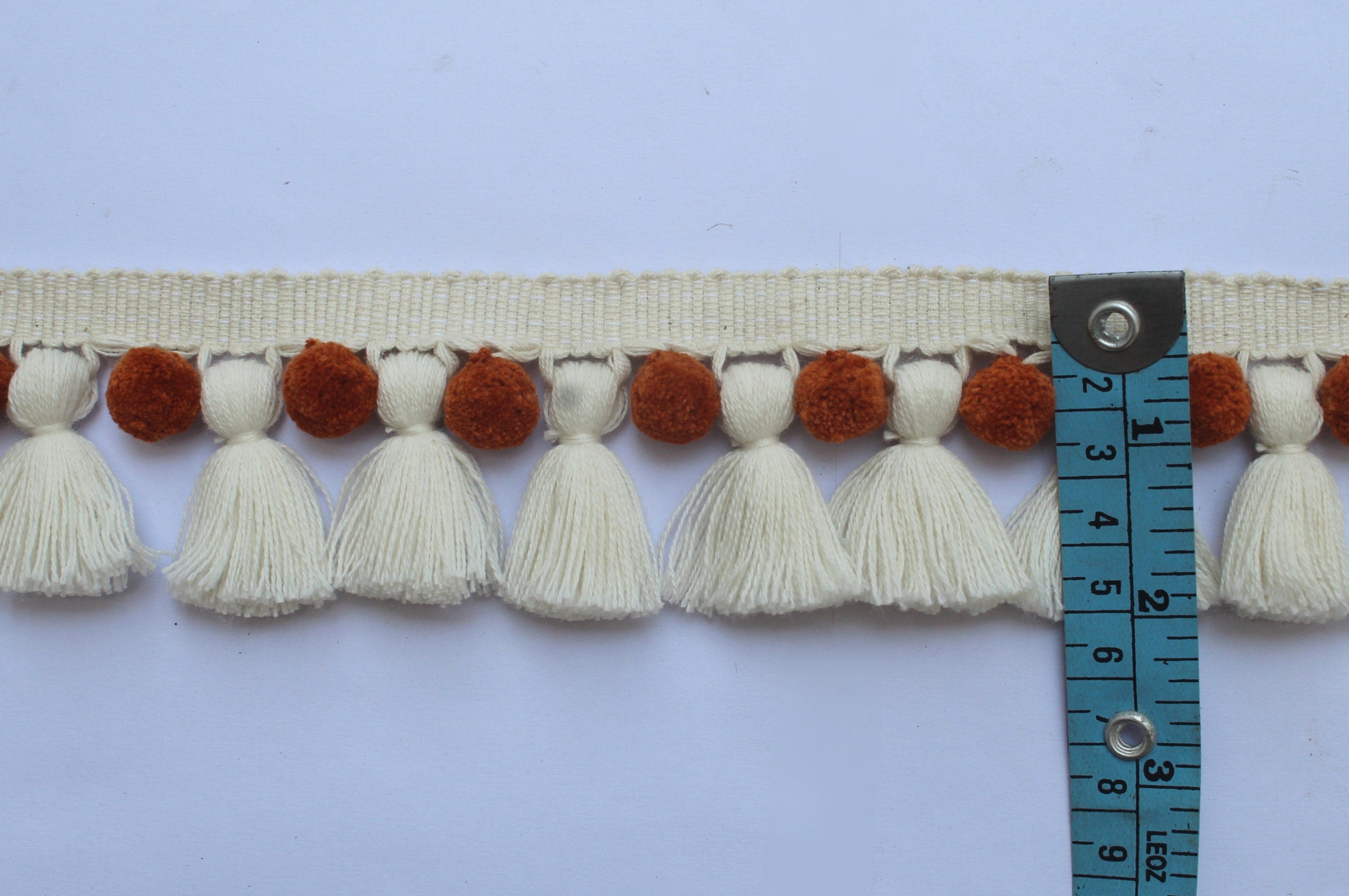 Saffron and ivory pom poms tassel trim