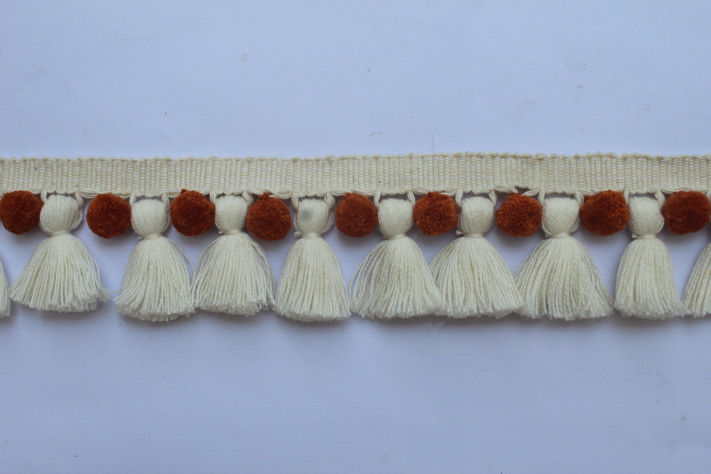 Saffron and ivory pom poms tassel trim